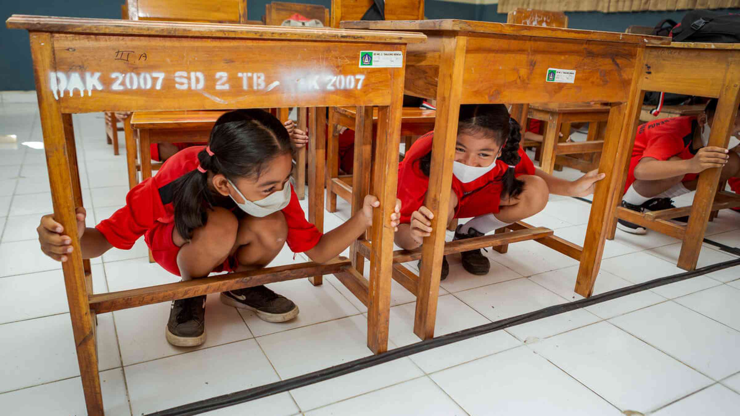 Children seek cover under their desks