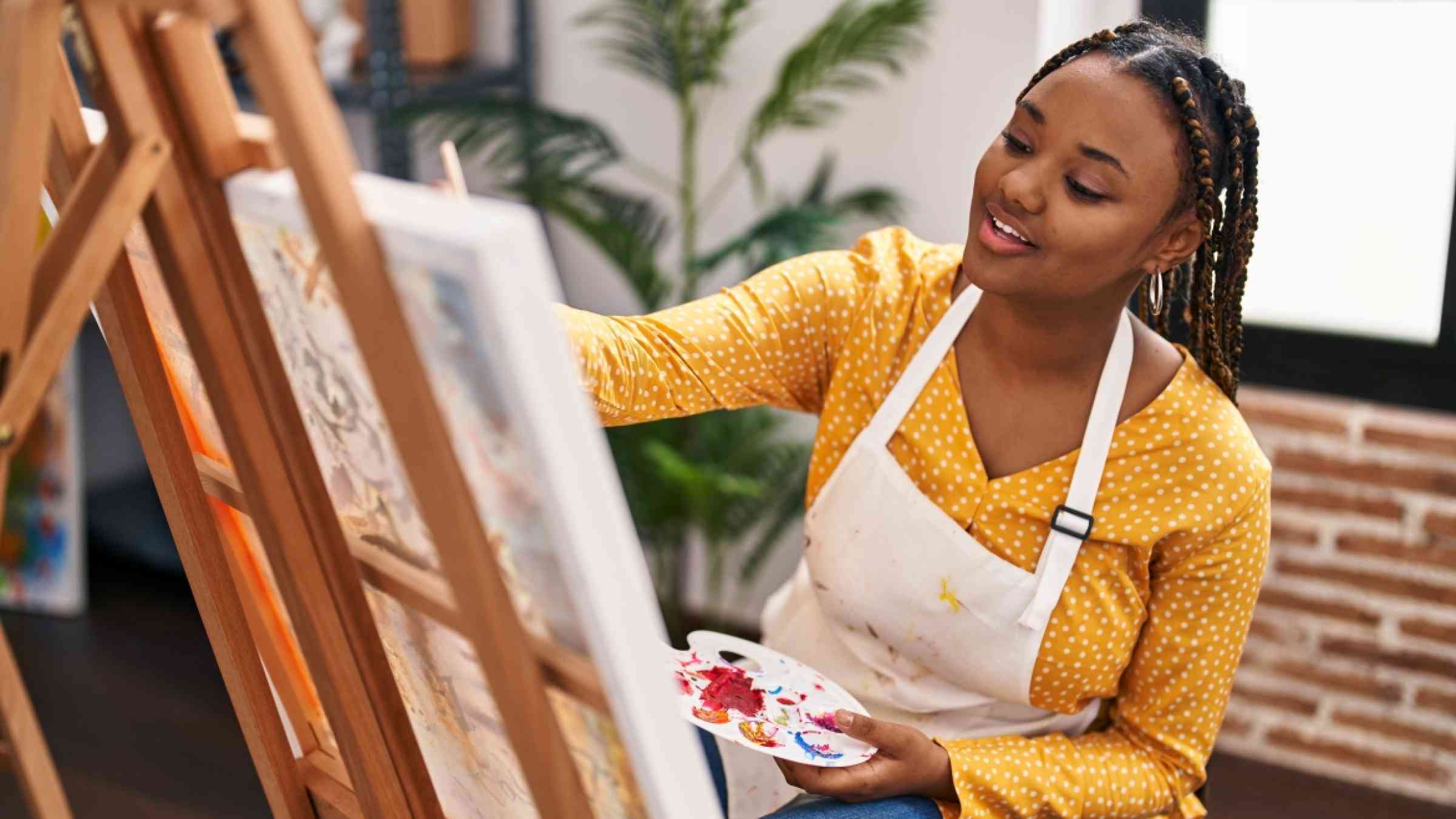 African Woman painting on an easel