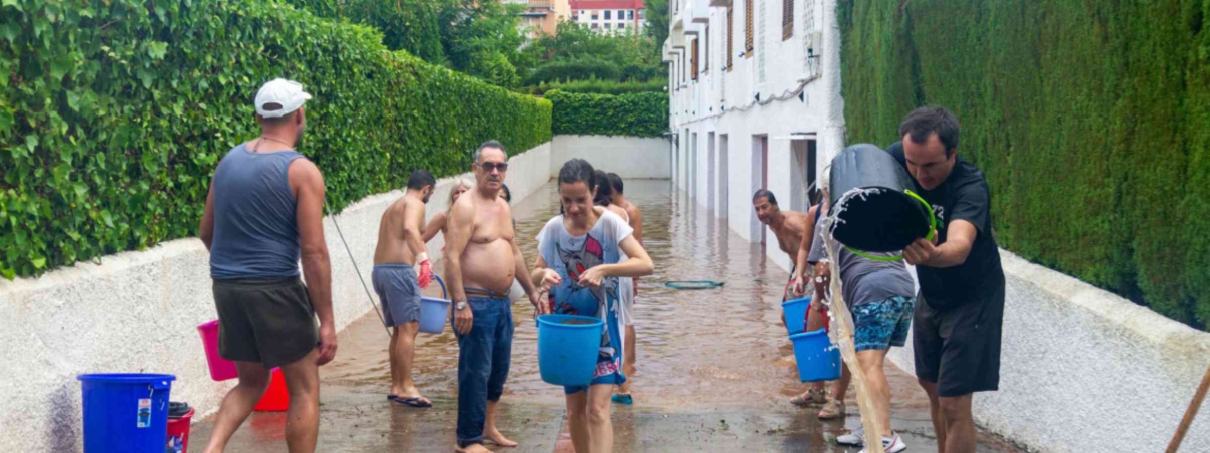 People helping drain water from a flooded house in Libya