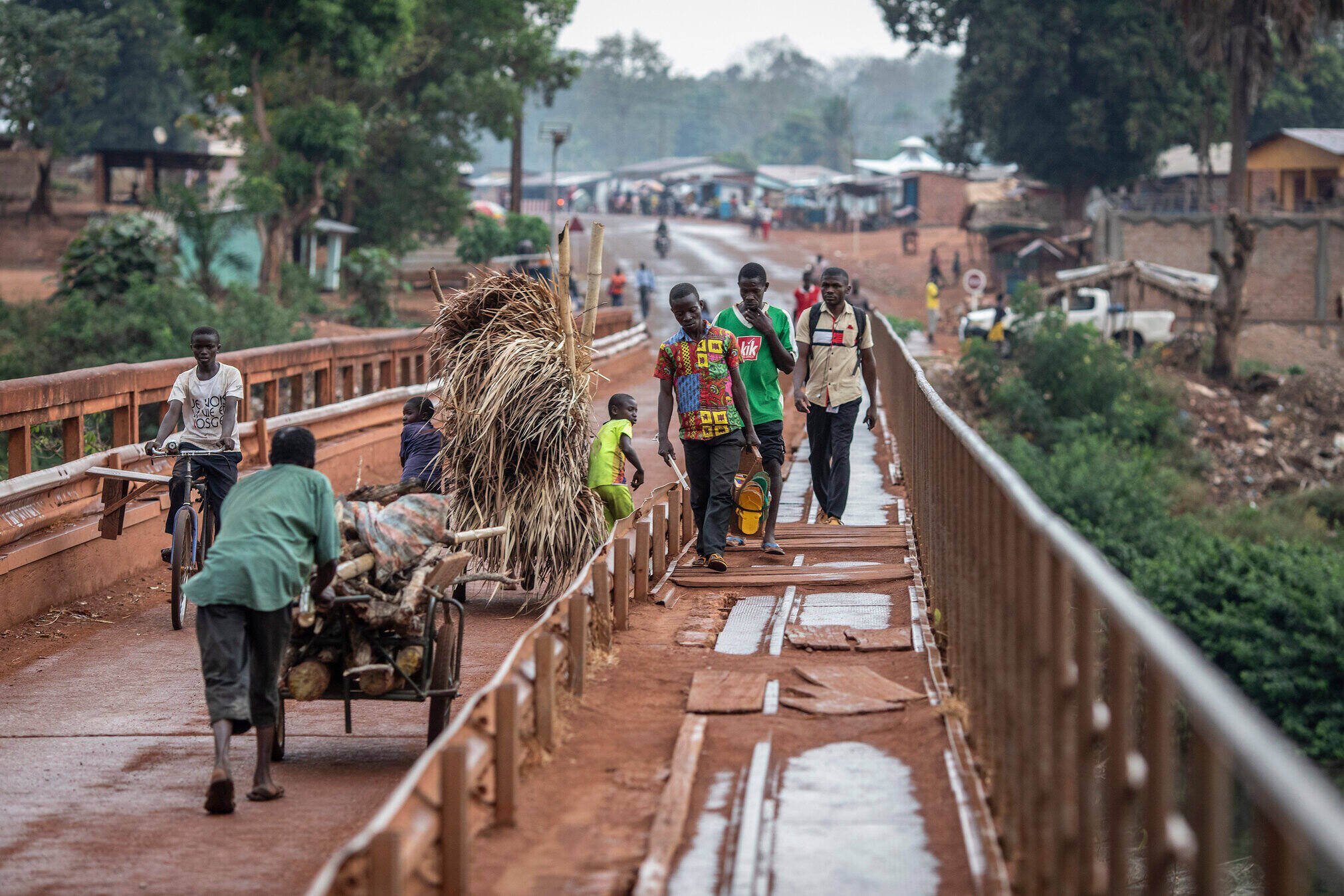 Pedestrians cross a bridge