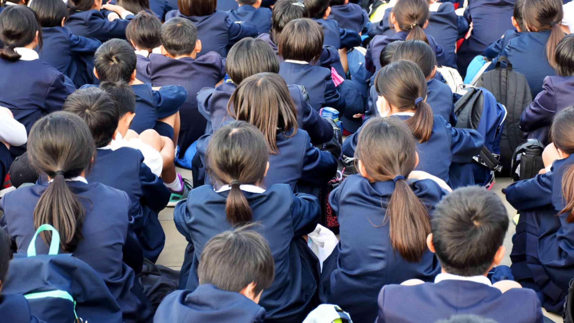 Crowd of Japanese highschool students wearing school uniforms