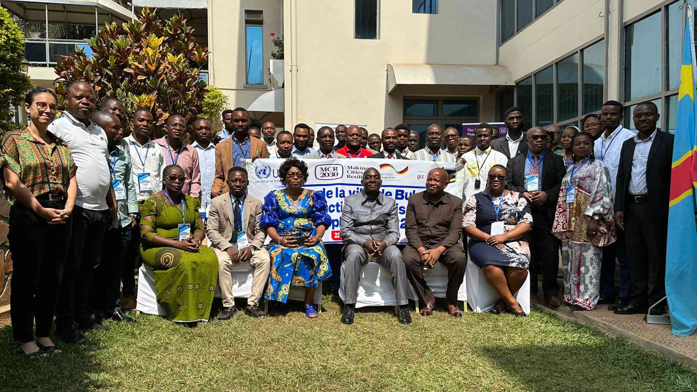 Participants of a workshop taking a group photo outside